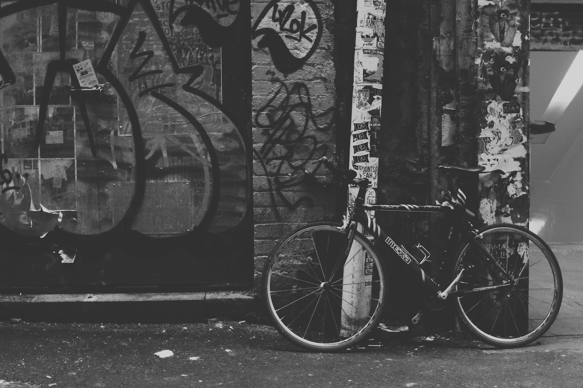 Bicycle next to graffiti wall