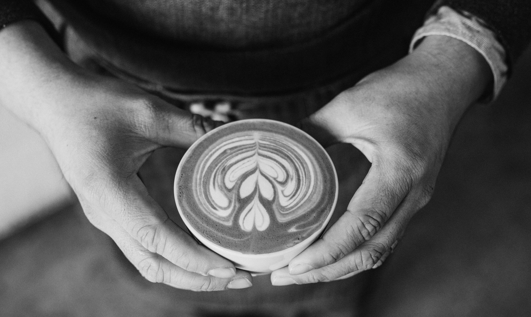 Holding a cup of coffee with both hands